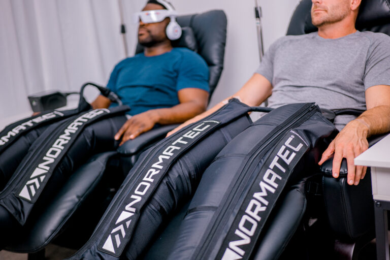 Two men undertaking compression therapy
