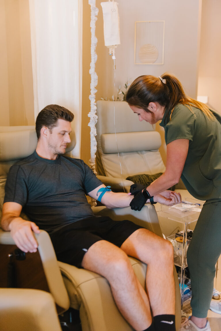Nurse assisting man at the start of IV therapy